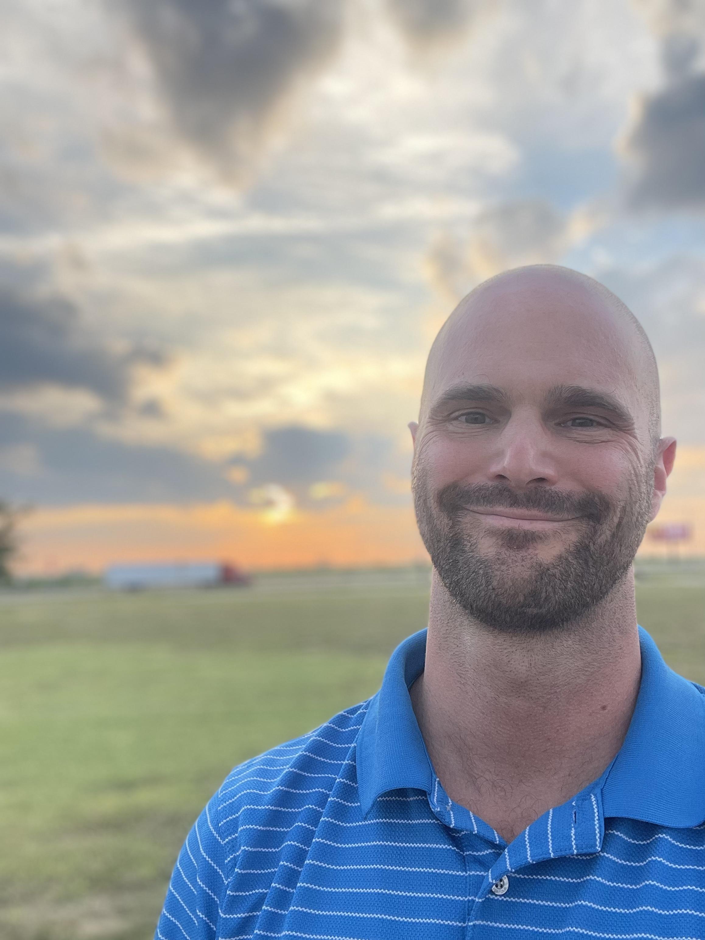 Charles, founder of Sors, smiling outdoors at sunset