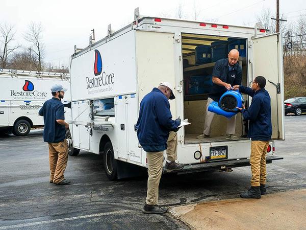 RestoreCore restoration contractors working on the truck