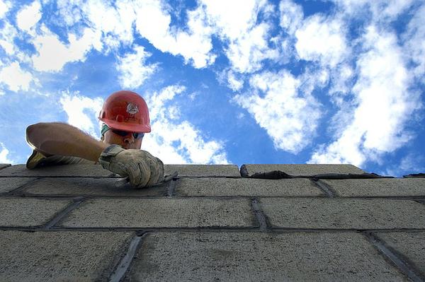 restoration contractor laying bricks