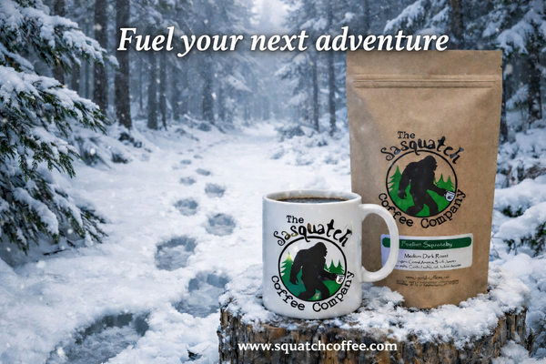 Sasquatch Coffee mug and coffee bag in a wintry forest setting