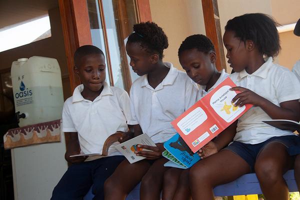 Group of young learners reading books
