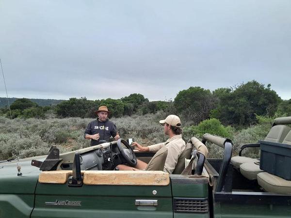 HillsNek team talking in safari vehicle