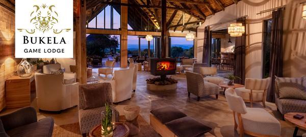 Comfortable indoor lodge with fire place and soft seating