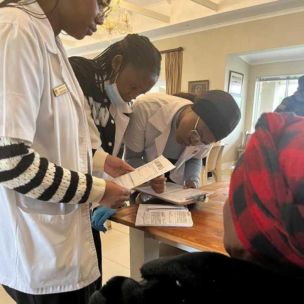 Nurses filling in forms at desk