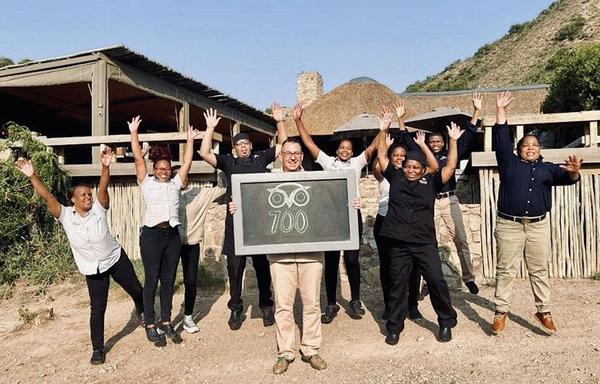 Staff group sitting in safari vehicles