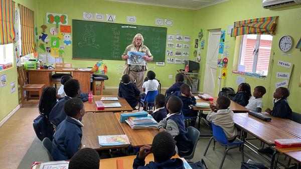 Educator teaching class of young learners