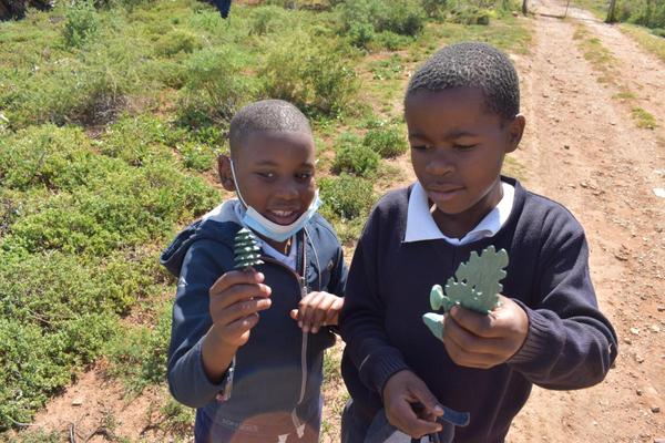 Two school children learning about Arbour Day, Amakhala Foundation