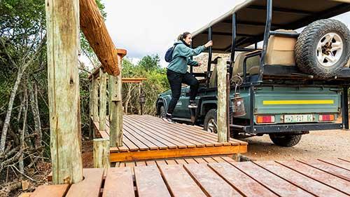 Person stepping onto Game Drive Vehicle