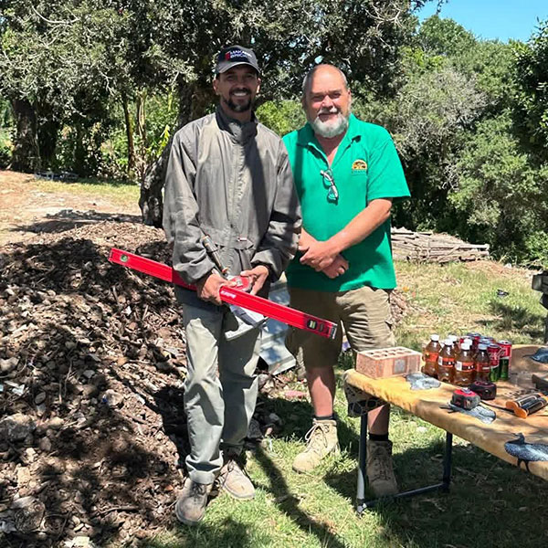 Two men standing in front of table