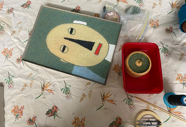 Completed beading project on floral table cloth