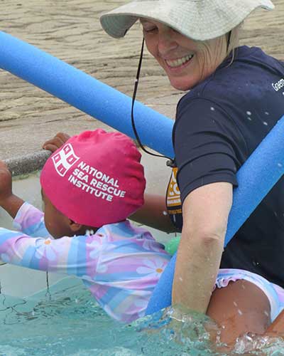 Child receiving a swimming lesson