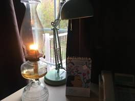 An oil lamp, burning.