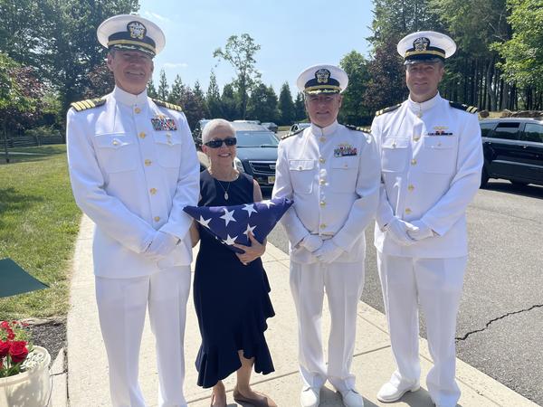 Anthony Di Petta's niece, Susanne Nakamura, with Lt. Raymond Donnelly (far right) and other sailors.