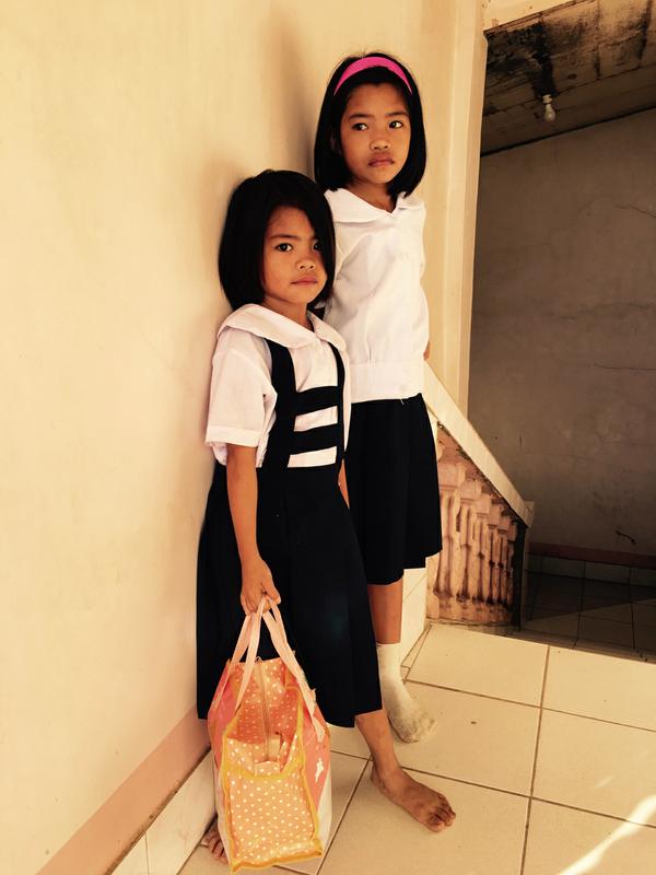 two little girls waiting for school luch