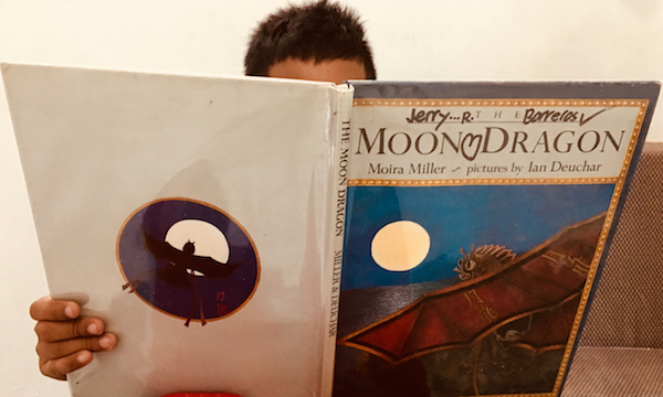 Jerry reading The Moon Dragon by Moira Miller