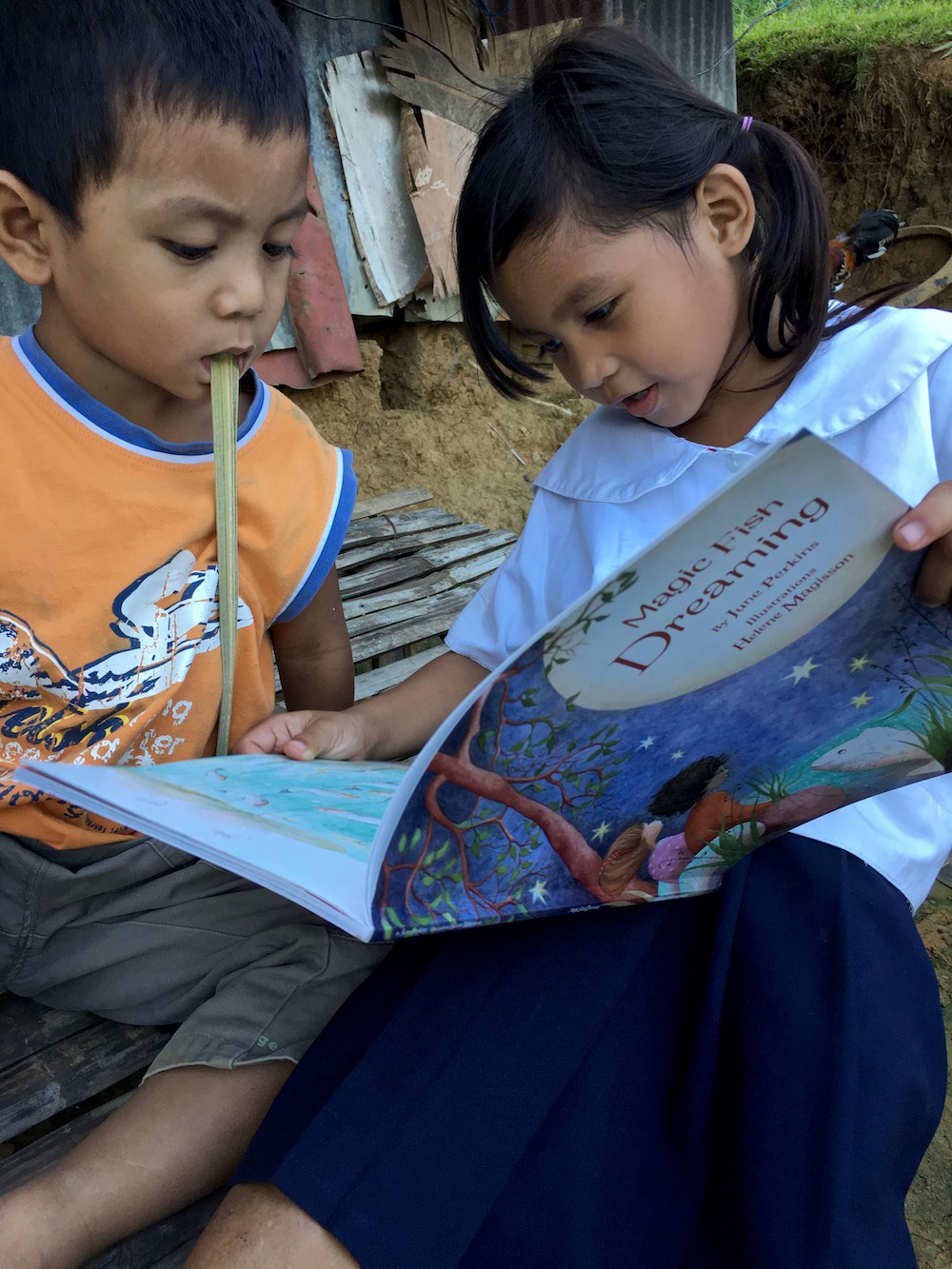 Children read Magic Fish Dreaming
