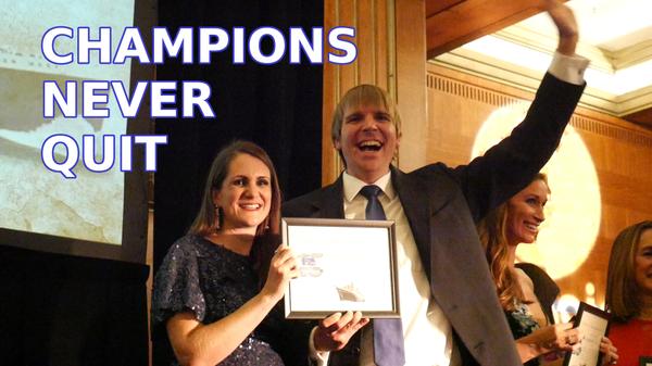 Tim and Cheri McGaffin awards ceremony - Champions Never Quit logo blurred.jpeg
