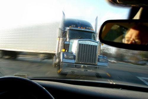 Large Truck coming head-on with a vehicle and driver