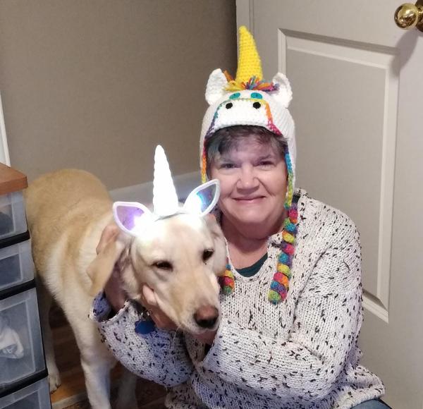 Nita Sweeney in a unicorn hat and Scarlet the pupperina in a unicorn headband