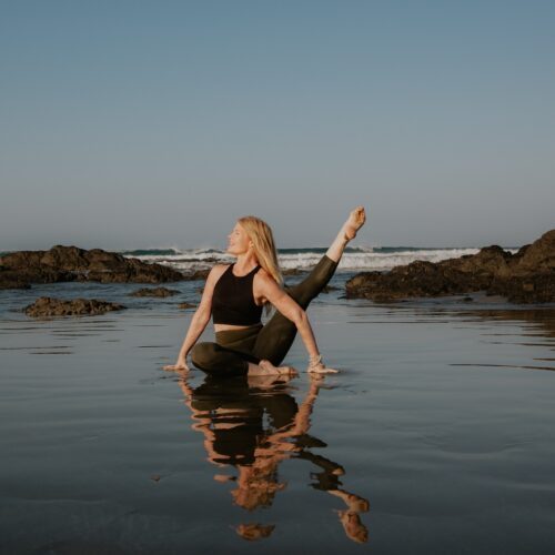Gioconda Parker in a yoga pose on the beach