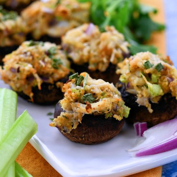 crab stuffed mushrooms on a white rectangle serving tray