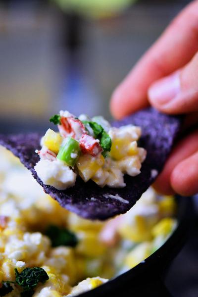 mayonnaise corn salad dipped with blue tortilla chip