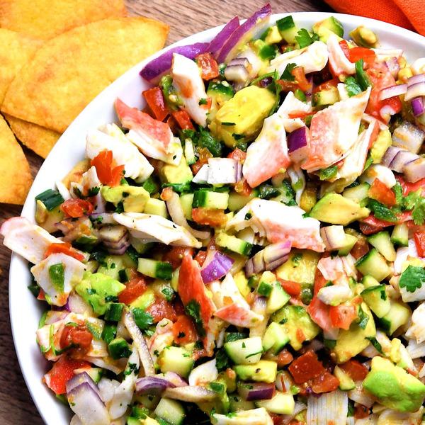 fresh mock crab ceviche on white plate with chips