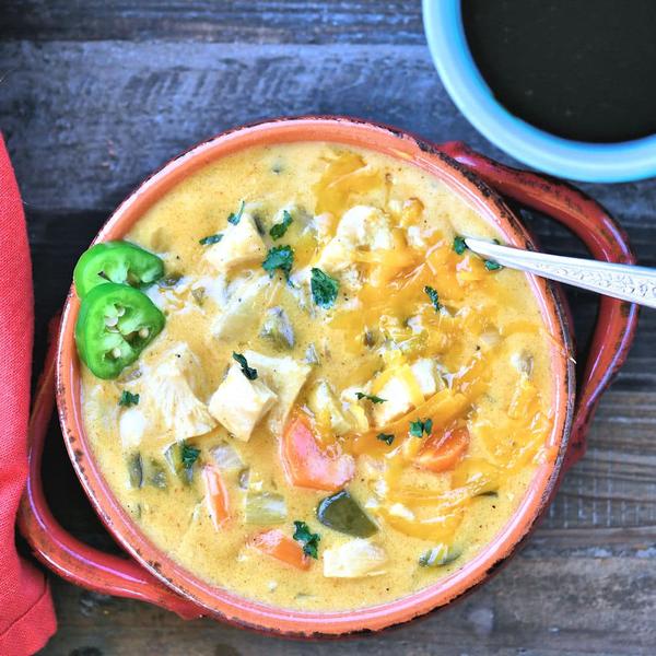 cheesy chicken poblano stew in a red Italian bowl