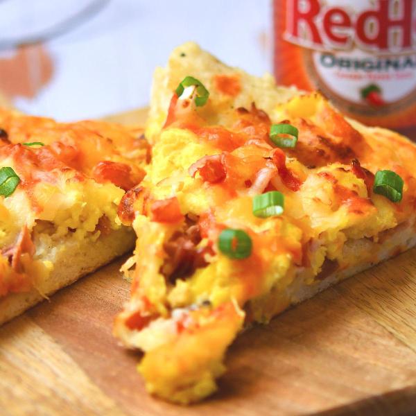closeup of bacon and eggs pizza slice