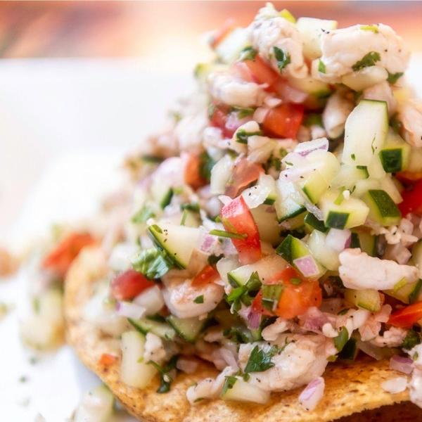 closeup of fresh shrimp ceviche on a tostada
