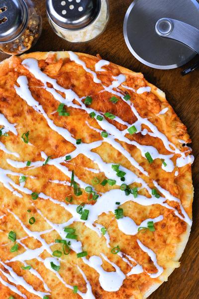 top down image of uncut buffalo chicken pizza
