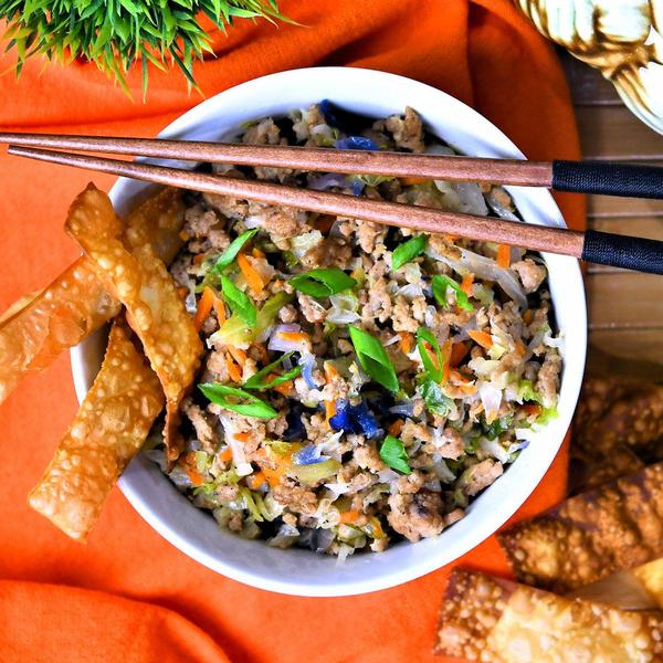 pork egg roll in a bowl with fried wonton strips