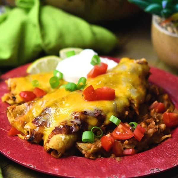 piece of taquitos casserole on red plate