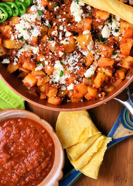 chorizo and potatoes in a red skillet