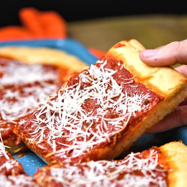 piece of Philly tomato pie in blue baking sheet