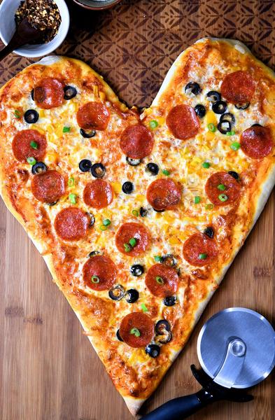 photo of heart-shaped pizza with pepperoni