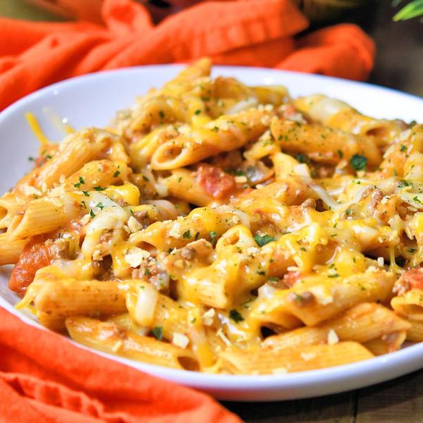 cheesy taco pasta on a white ceramic plate