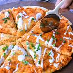buffalo chicken pizza with white pizza cutter