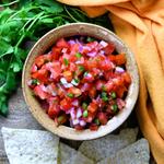 fresh pico de gallo in a brown ceramic bowl