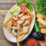 pork tamales on an oval plate