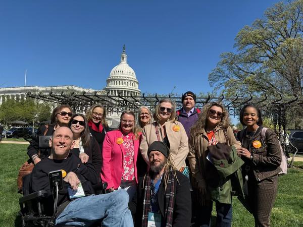 A group of smiling self-advocates from Texas pose on the U.S. Capitol lawn during last week's "Protect Medicaid" rally.
