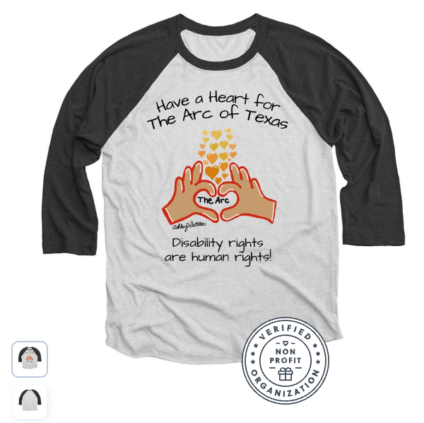 A gray baseball-style T-shirt with dark charcoal sleeves is displayed against a light background. The front design reads, “Have a Heart for The Arc of Texas” above an illustration of two hands forming a heart shape around the words “The Arc,” with small yellow and orange hearts rising above. Below the image, the
text says, “Disability rights are human rights!”