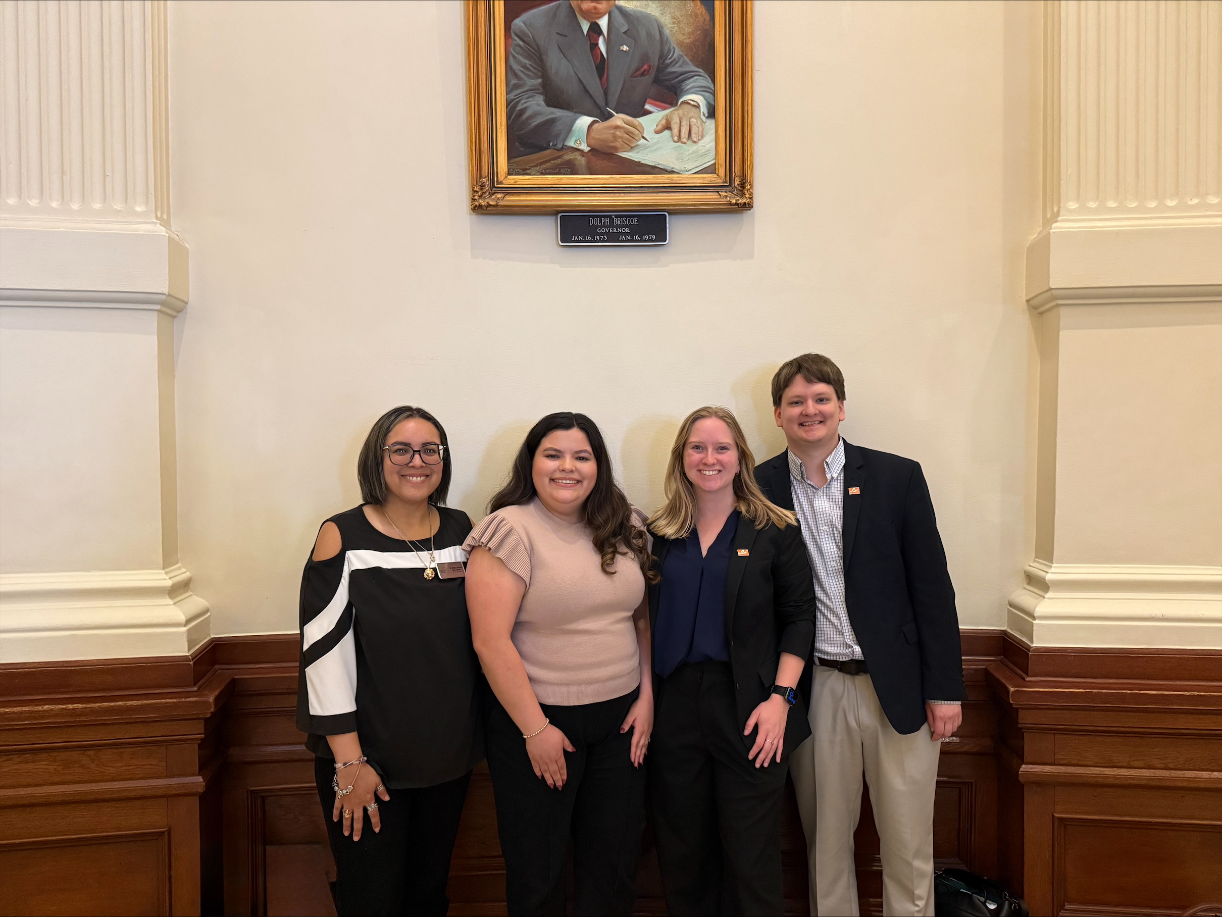 Dr. Melisa Rosario, Sabrina Gonzalez Saucedo, Kate Stoops and Michael Clarke pose for a photo inside the Texas Capitol.