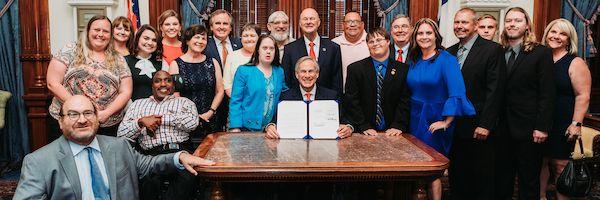 A group photo of advocates with Texas Gov. Greg Abbott