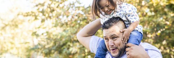 A father carries his young son on his shoulders