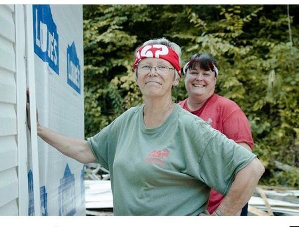 Christie (left) and daughter Missy (right) installing siding on a home in Harlan, Kentucky