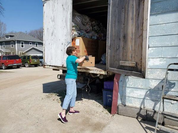 Lisa Fuller unloading boxes of cans at her can redemption center
