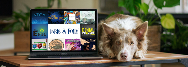 Cute brown and white collie next to a laptop showing some of the new Fable and Folly Network shows.