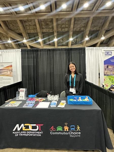 Nikki Transmonte tabling at an outreach event with commuter choice maryland swag