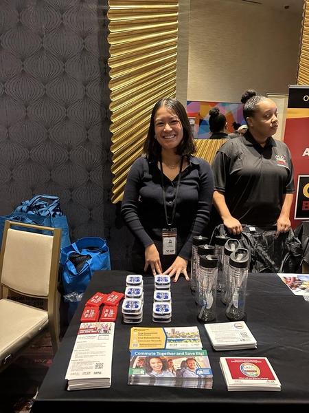 Nikki Transmonte tabling at an outreach event with commuter choice maryland swag